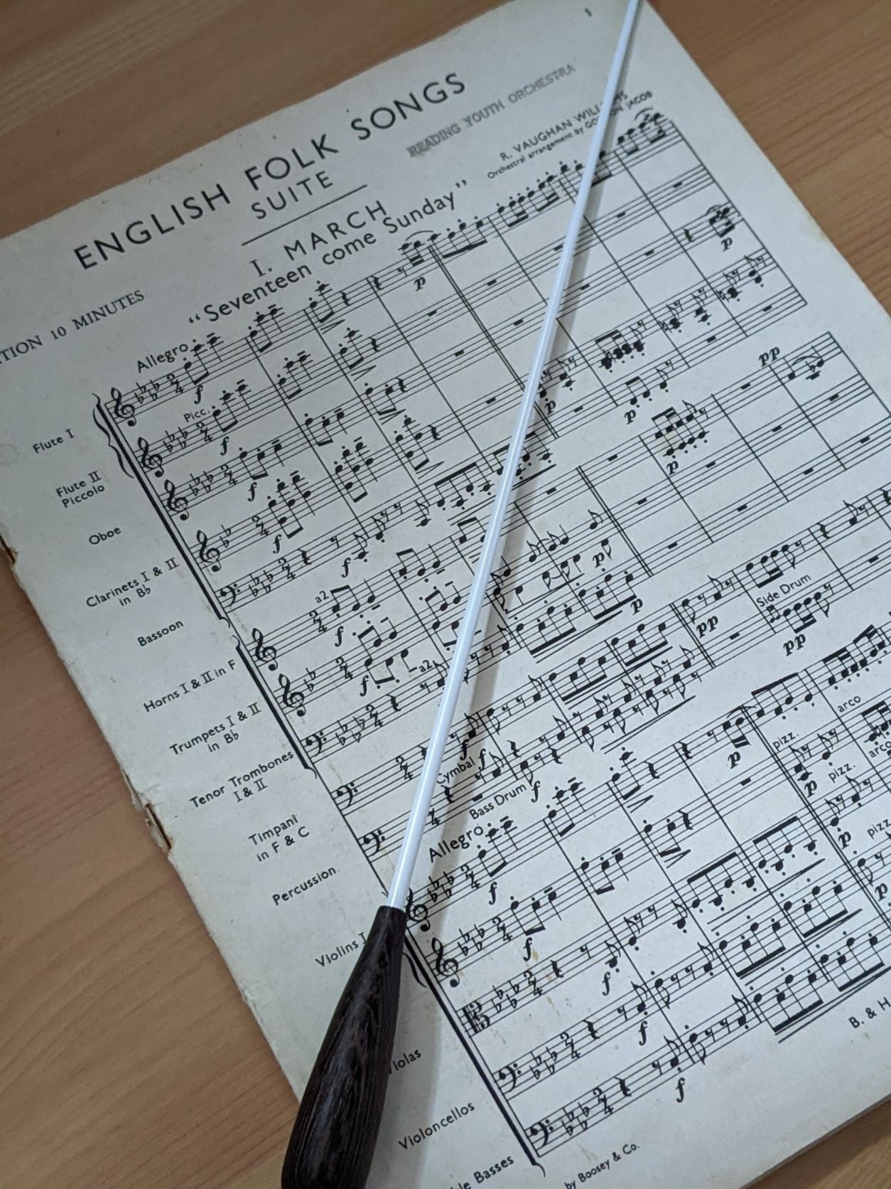 Front page of English Folk Songs Suite score, by Vaughan Williams, with a conductor's baton
